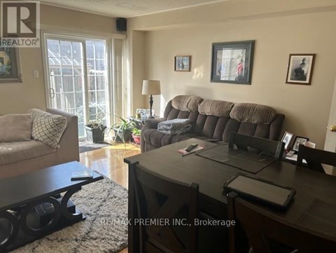A living room with a grey couch and a black coffee table.