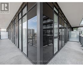 A modern interior space with large glass walls and a view of the city.
