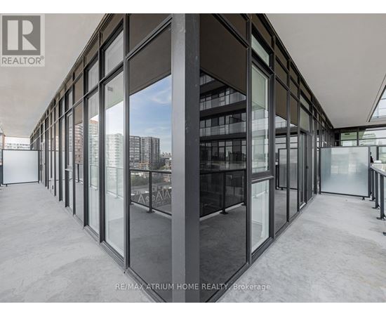 A modern interior space with large glass walls and a view of the city.