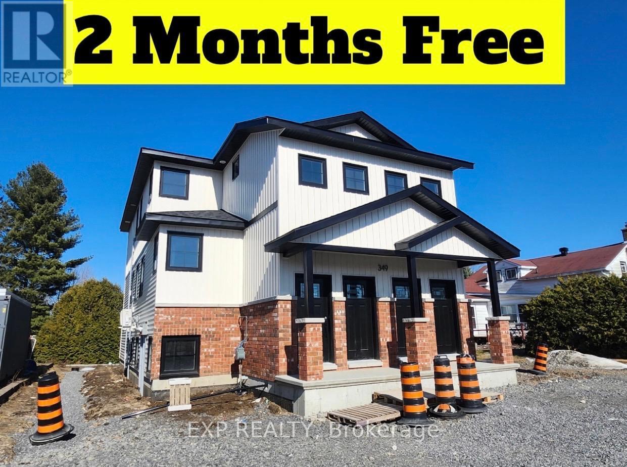 A house under construction with a sign offering 2 months free.