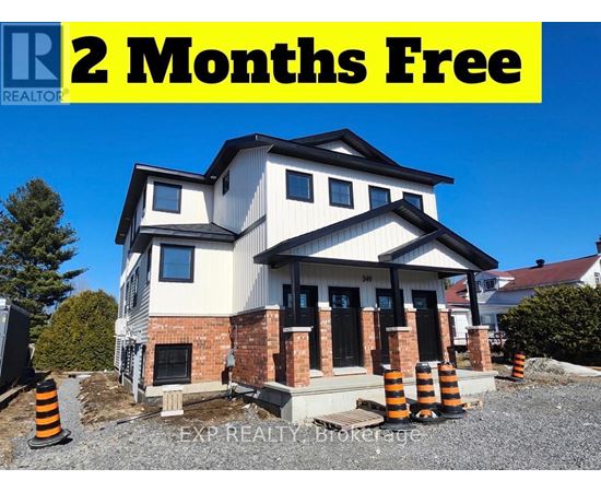 A house under construction with a sign offering 2 months free.