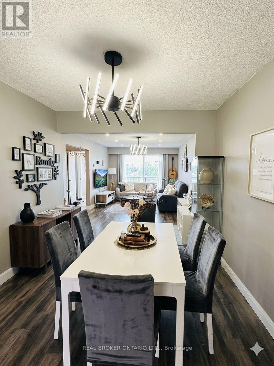 A dining room with a white table and black chairs.