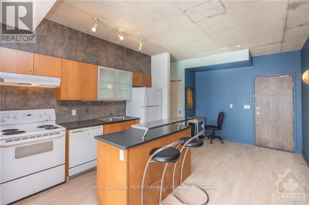 A kitchen with white appliances and wooden cabinets.
