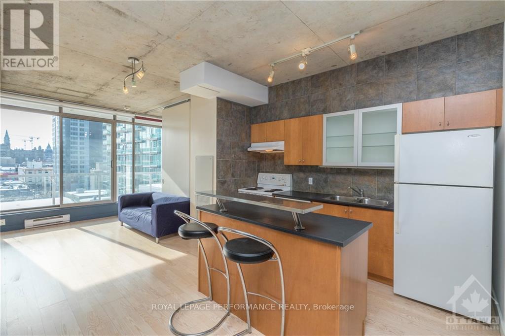 A kitchen with a bar stool and a counter top.