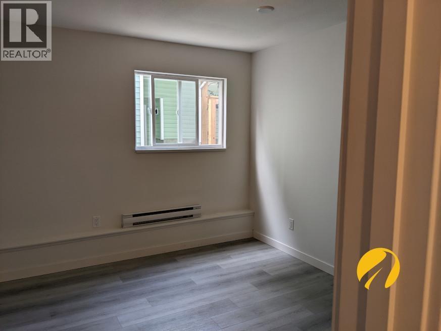 A room with a window and a radiator on the wall.