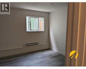 A room with a window and a radiator on the wall.