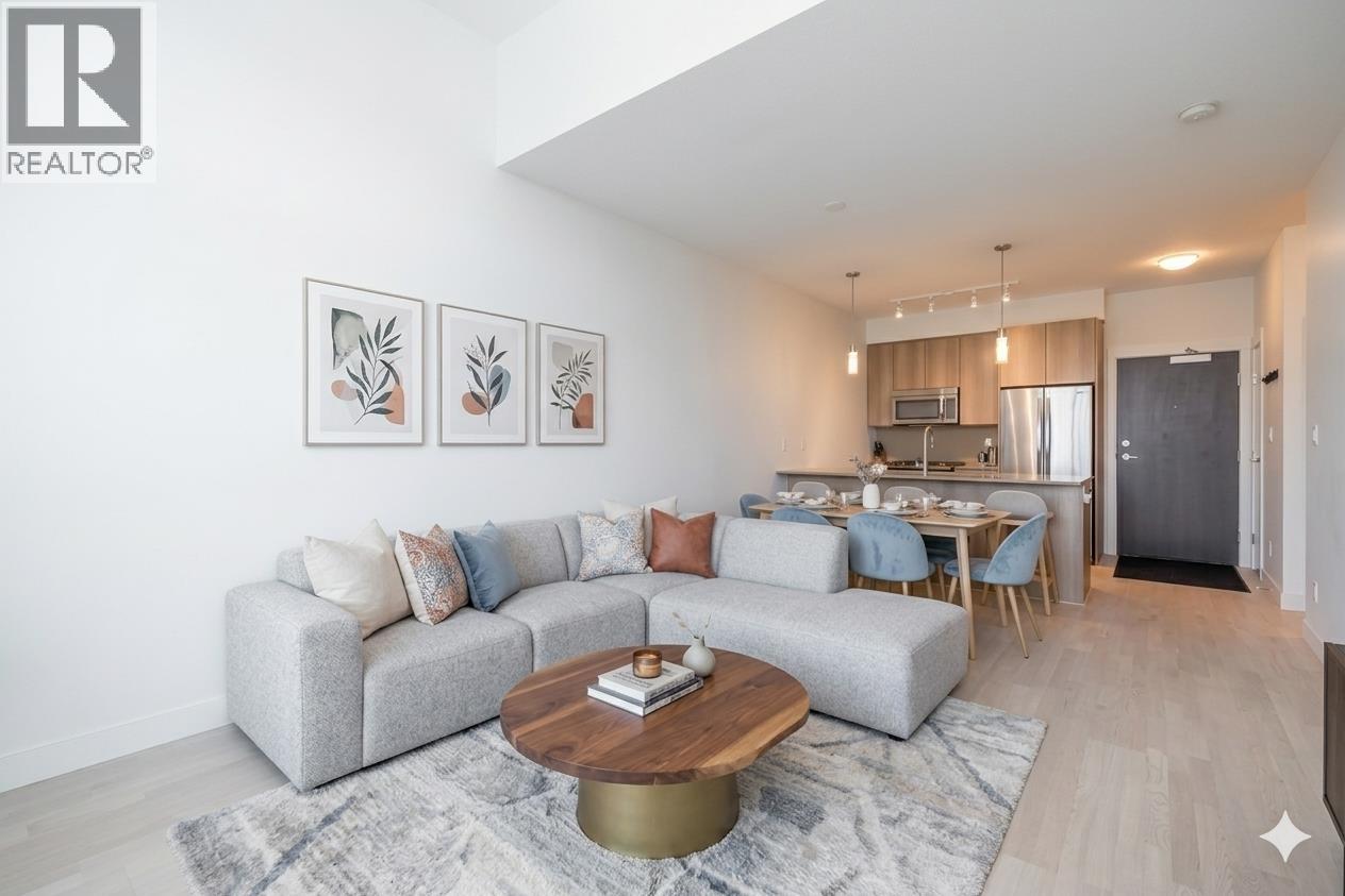 A living room with a grey couch and a coffee table in front of it.