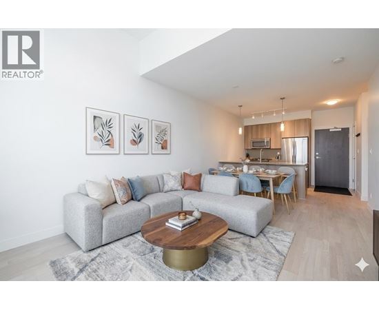 A living room with a grey couch and a coffee table in front of it.