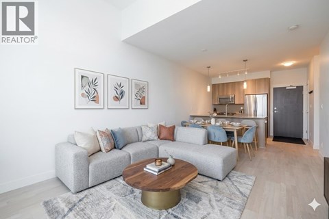 A living room with a grey couch and a coffee table in front of it.