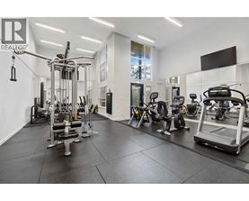 A well-equipped gym with various exercise machines and weights.