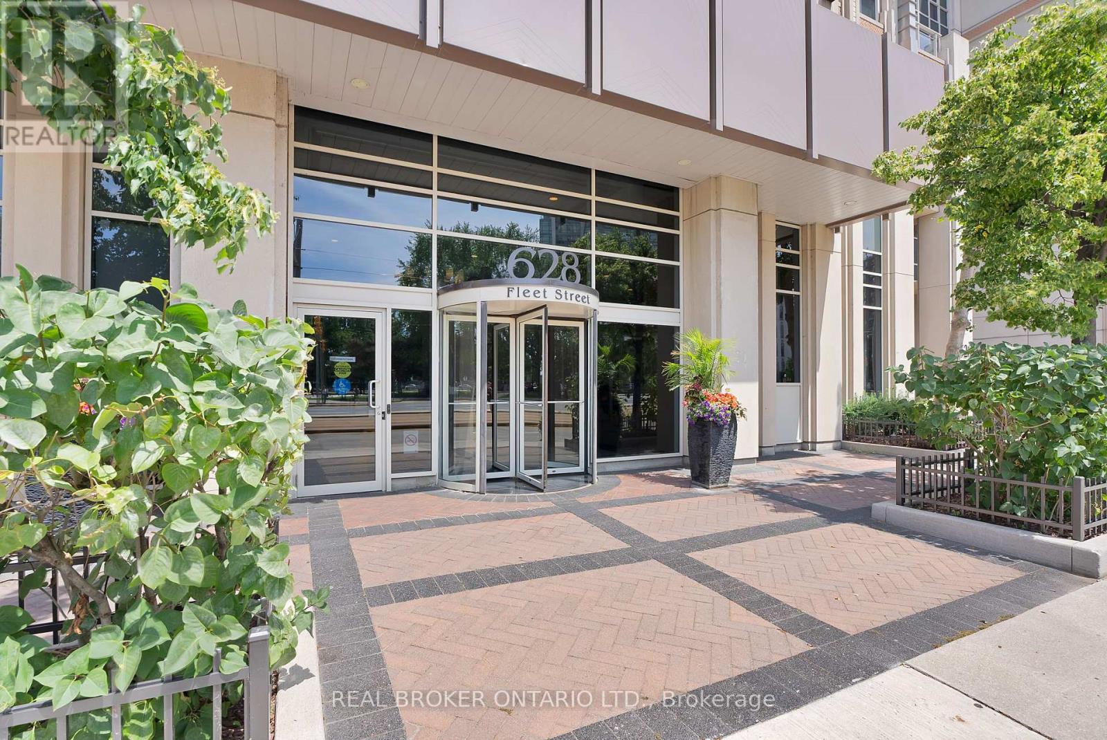 The image shows the entrance to a building with glass doors and windows, and a sign that reads "Fleet St."
