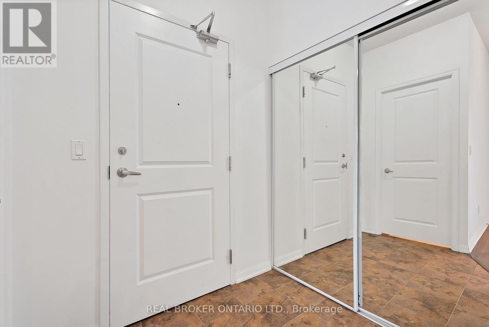 A white door with a Real Broker Ontario Ltd. logo on it.