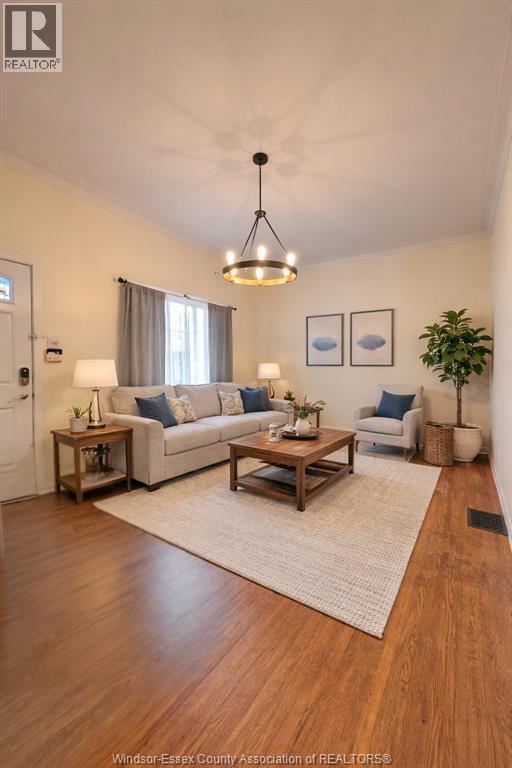 A living room with a white couch, a wooden coffee table, and a rug.
