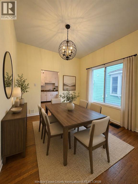A dining room with a wooden table and chairs.