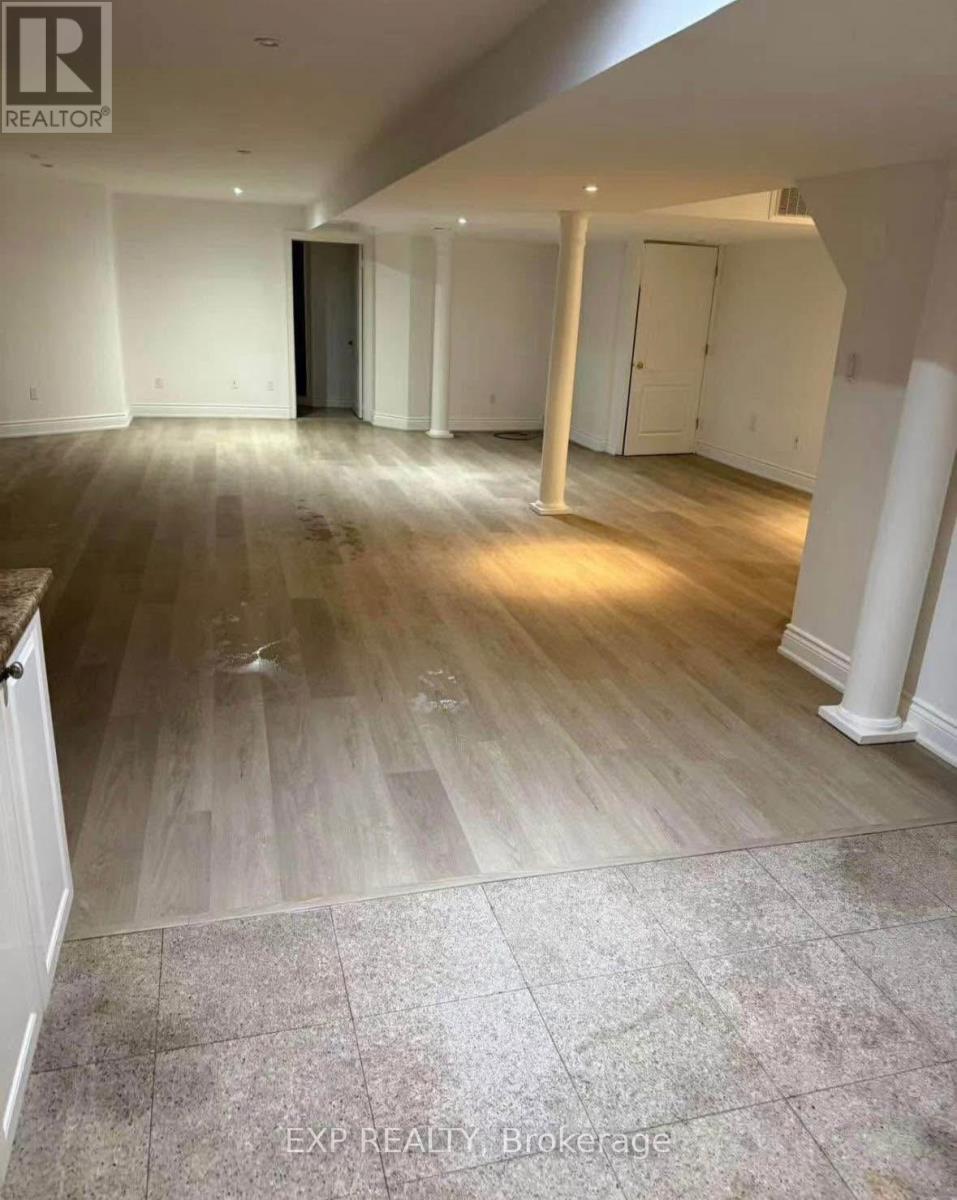 A room with wooden flooring and white walls.