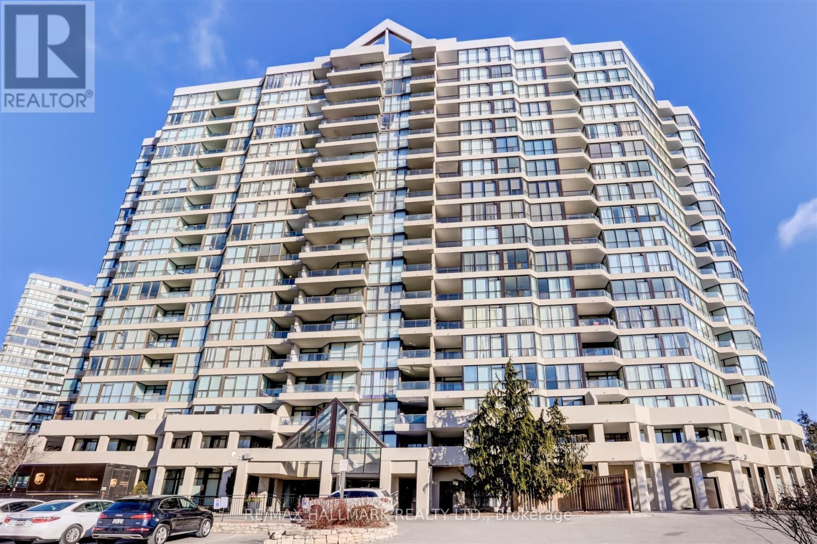 A tall residential building with a clear blue sky in the background.