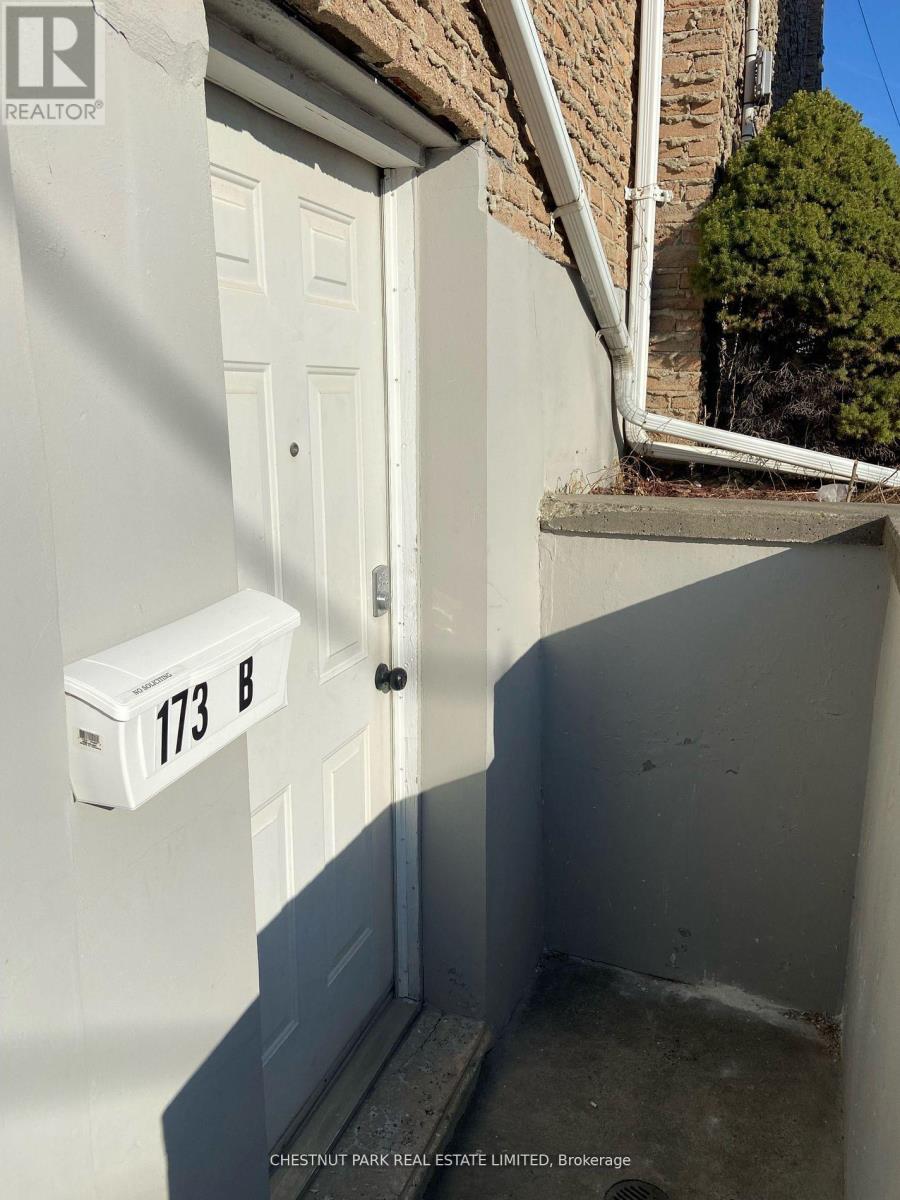 A white door with a mailbox on the wall.
