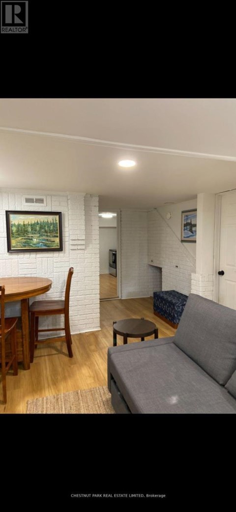 A living room with a grey couch and a wooden table.
