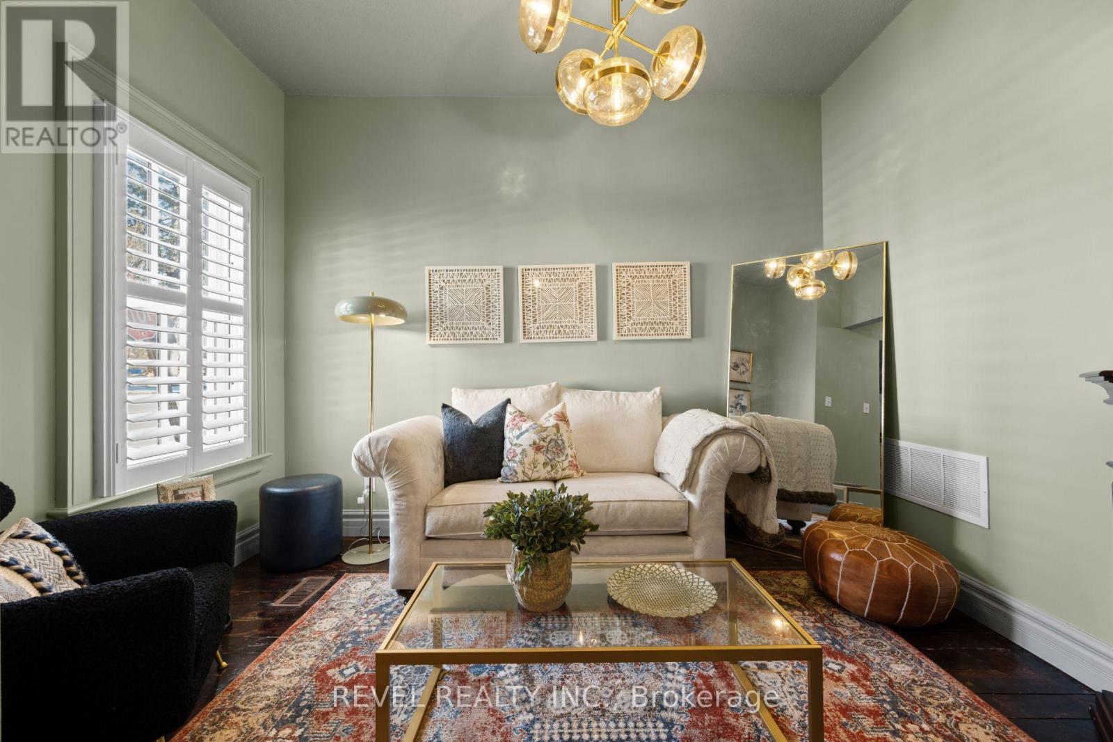 A living room with a couch, chairs, and a coffee table.