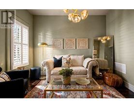 A living room with a couch, chairs, and a coffee table.