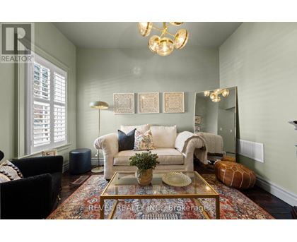 A living room with a couch, chairs, and a coffee table.
