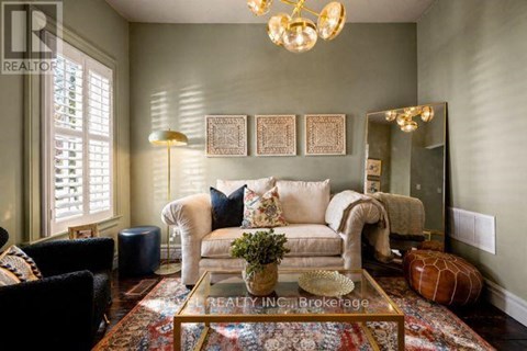 A living room with a couch, chairs, and a coffee table.