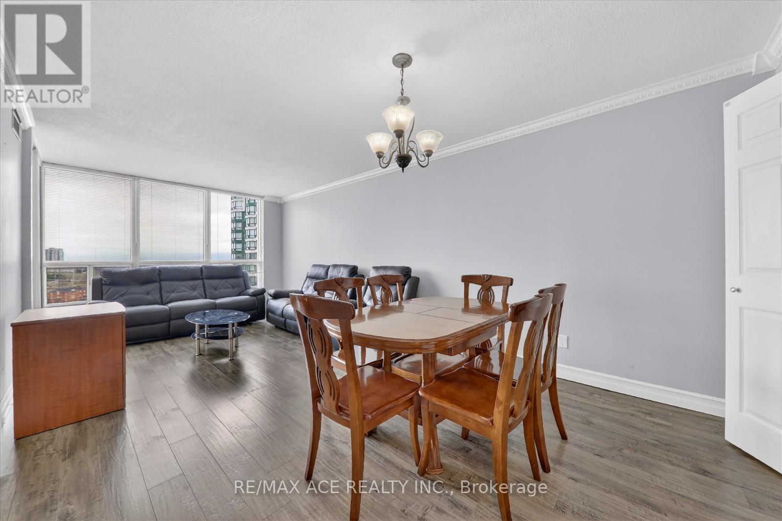 A dining room with a wooden table and chairs.