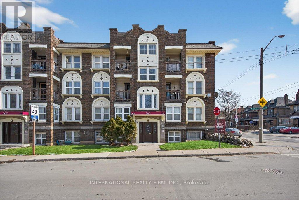 A street view of a building with the sign "INTERNATIONAL REALTY FIRM, INC., Brokerage" in front of it.