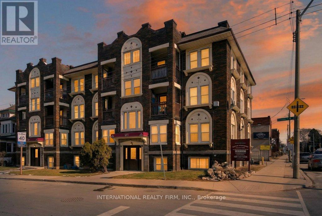 A building with the sign "INTERNATIONAL REALTY FIRM, INC., Brokerage" in front of it.