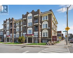 A street view of a multi-story building with a sign for International Realty Firm, INC. on the bottom.