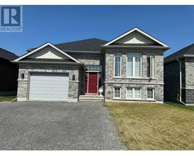 A house with a red door and a garage door is for sale.