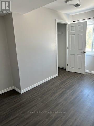 A room with a white door and grey walls.