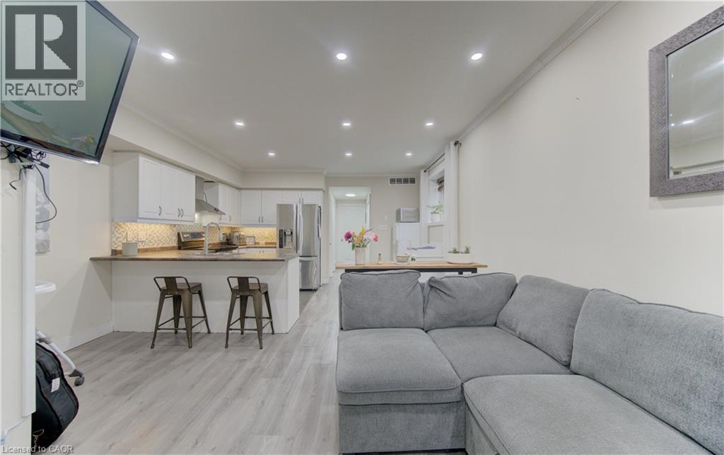 A grey couch is in the middle of a living room.