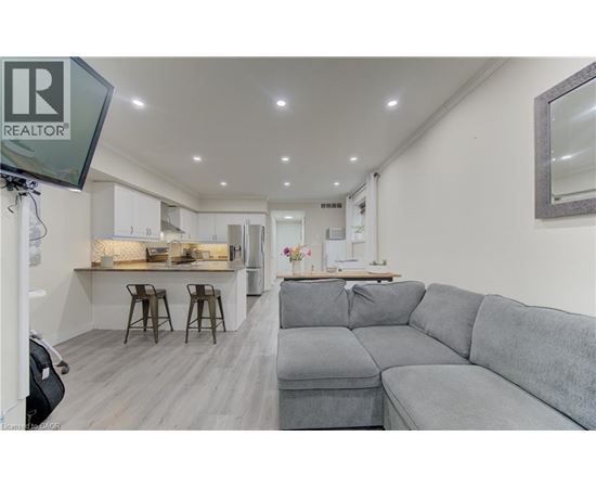 A grey couch is in the middle of a living room.