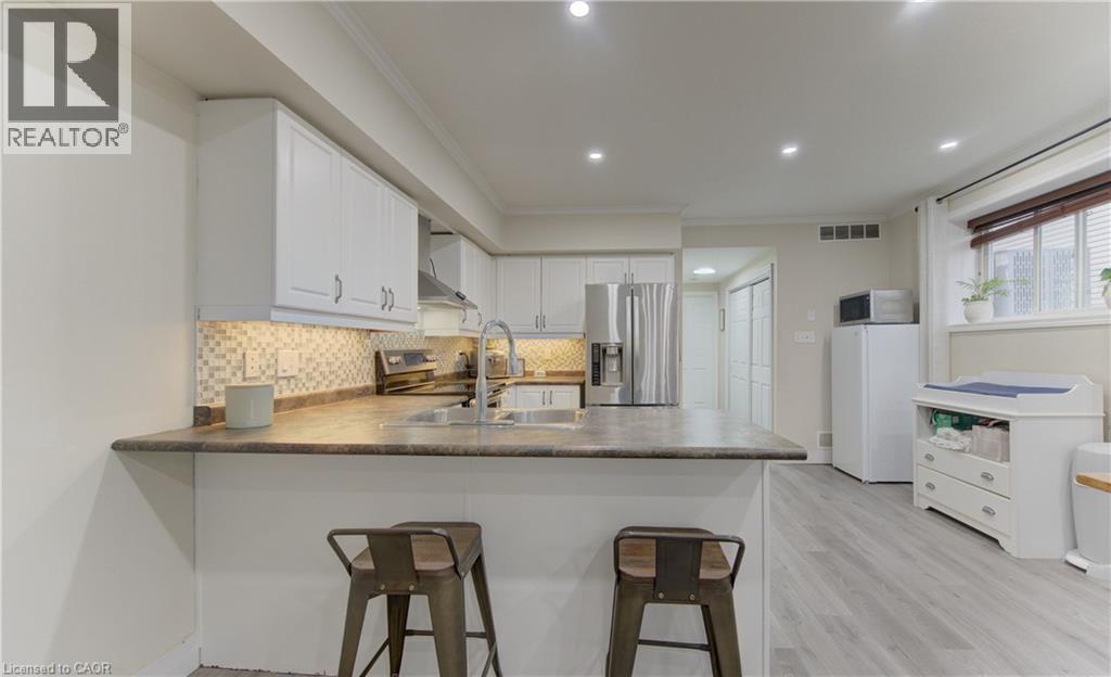 A modern kitchen with white cabinets and a central island.
