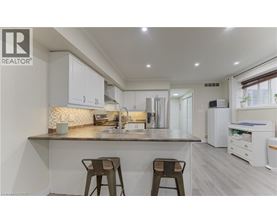 A modern kitchen with white cabinets and a central island.