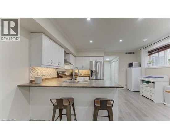 A modern kitchen with white cabinets and a central island.