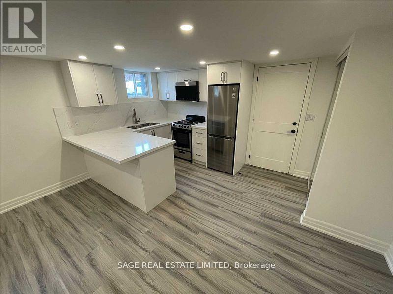 A kitchen with a refrigerator, stove, and oven.
