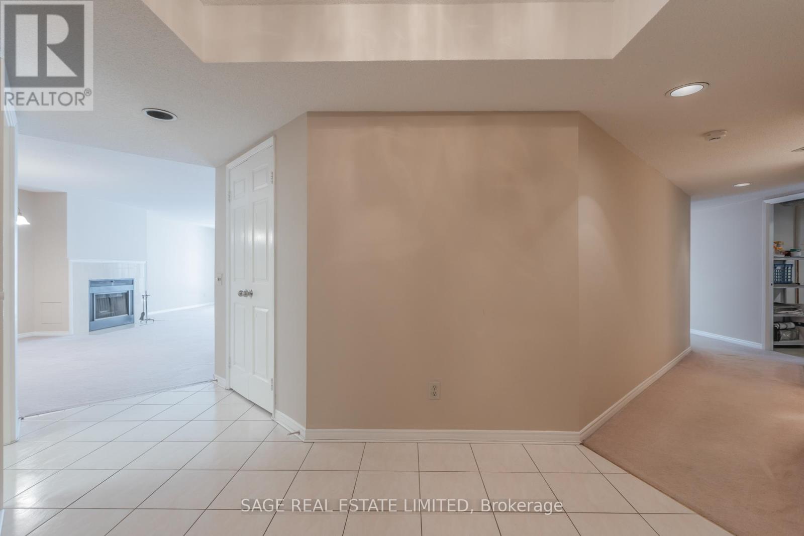 A spacious room with a doorway leading to another room.