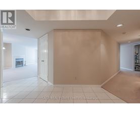 A spacious room with a doorway leading to another room.