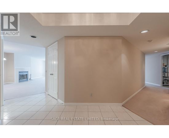 A spacious room with a doorway leading to another room.