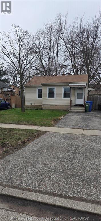 A house with a driveway in front of it.