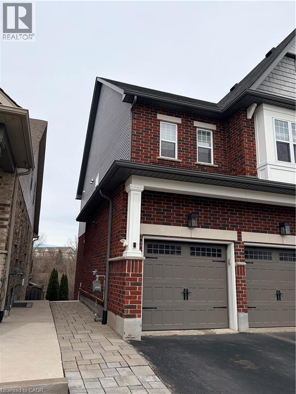 A house with a brick facade and a grey garage door.
