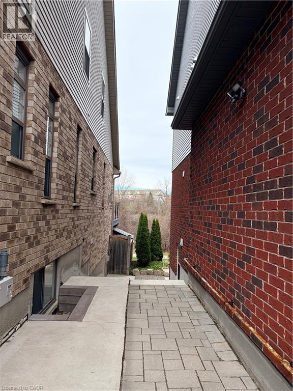 A brick building with a small tree in the backyard.