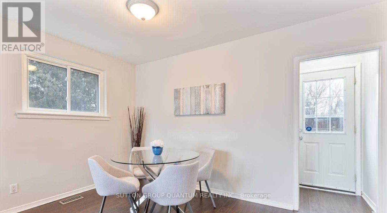 A dining room with a glass table and chairs.