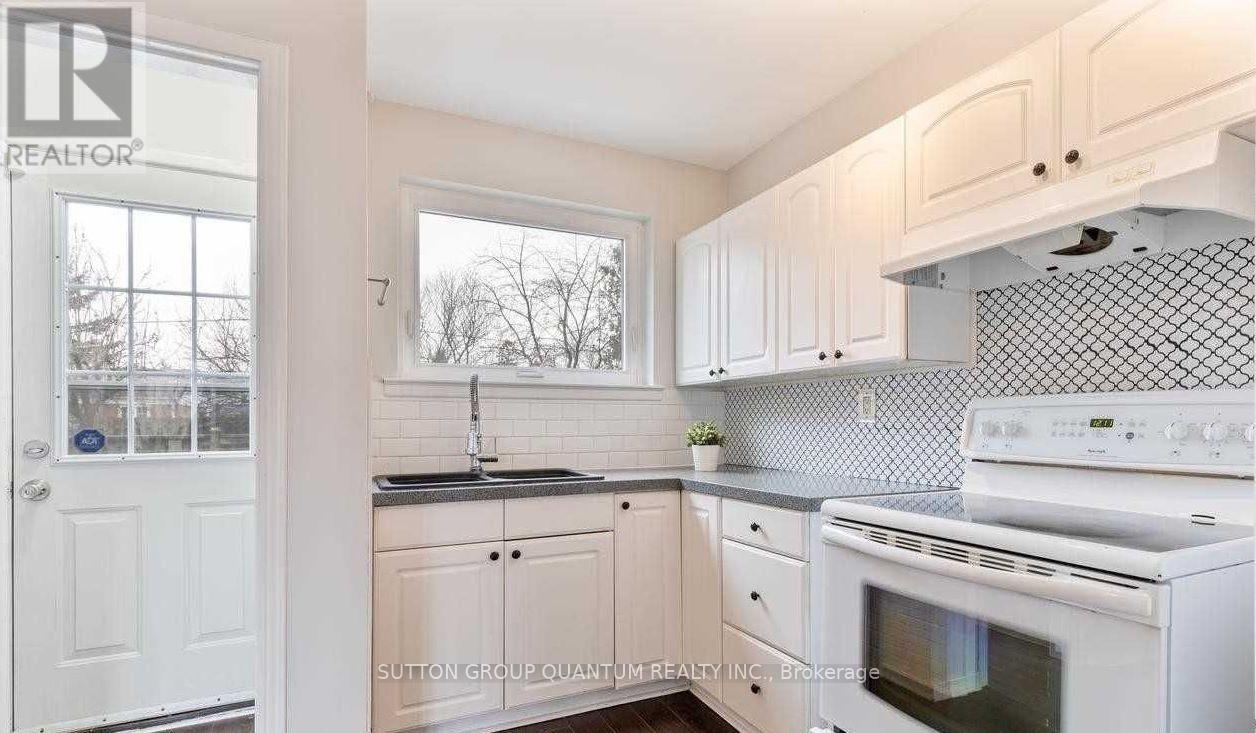 A kitchen with white cabinets and a white oven.