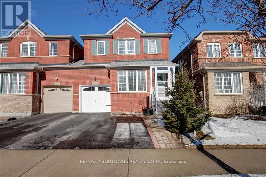 A large brick house with a white garage door is for sale.
