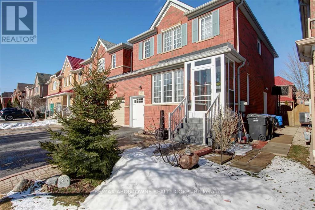 A red brick house with a white door and windows.