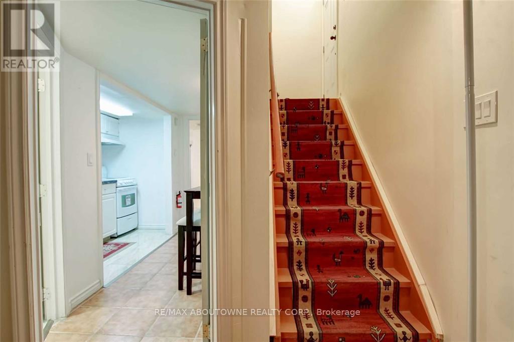 A staircase with a red carpet and wooden steps.