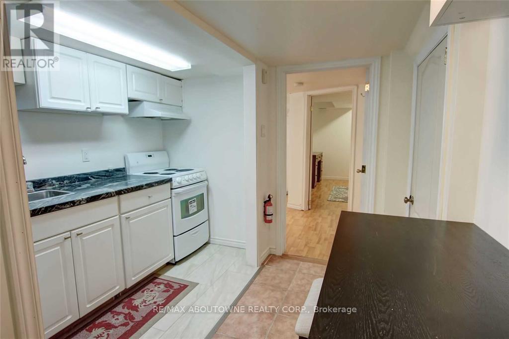 A kitchen with white cabinets and a black countertop.